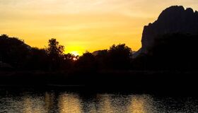 Begin your travel day with Vang Vieng’s serene ambiance